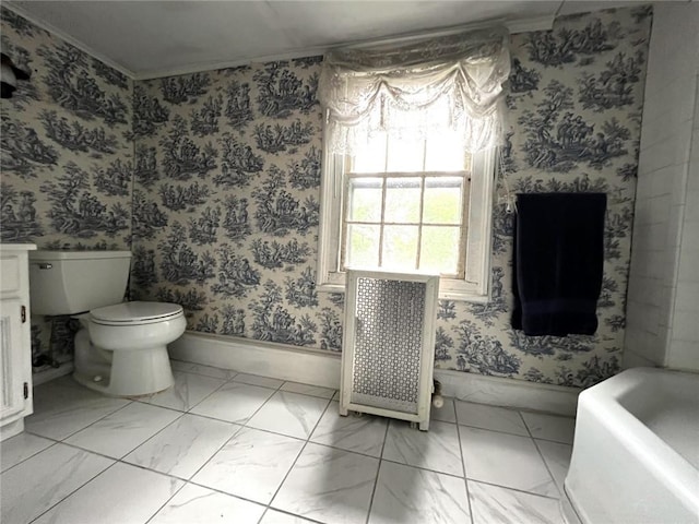 bathroom with a bathing tub, toilet, radiator heating unit, and crown molding