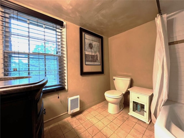 bathroom with tile patterned floors, heating unit, shower / tub combo, and toilet