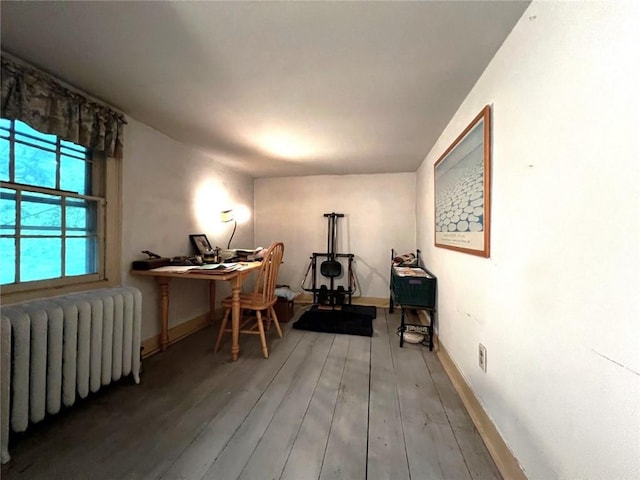 home office featuring radiator heating unit and hardwood / wood-style floors