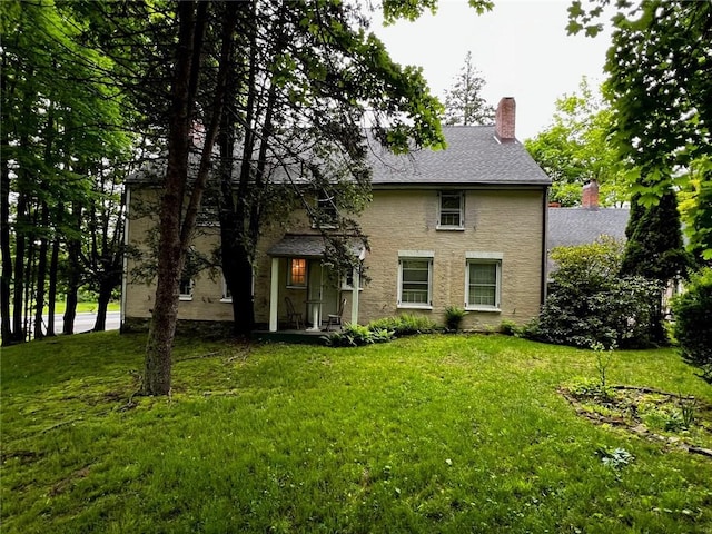 rear view of house with a yard