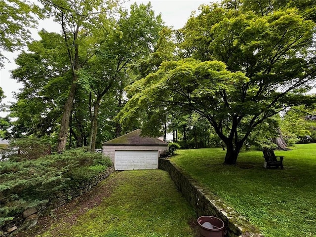 view of yard with a garage and an outdoor structure