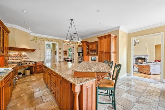 kitchen with a breakfast bar area, a large island, and ornamental molding