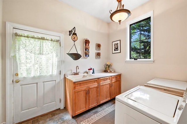 washroom featuring washer and clothes dryer, sink, and cabinets