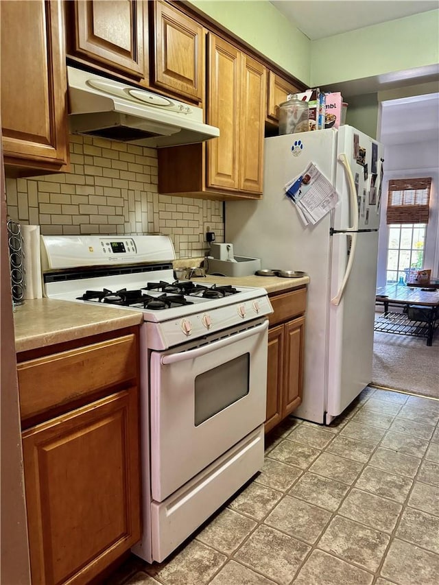 kitchen with white appliances and backsplash