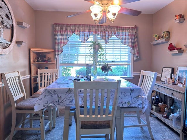 dining space featuring tile patterned floors and ceiling fan