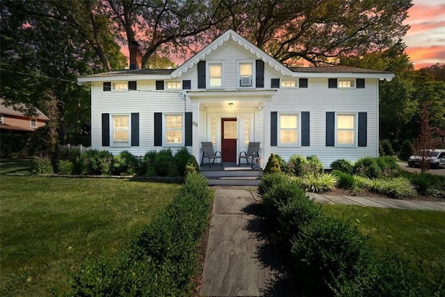 colonial-style house featuring a yard