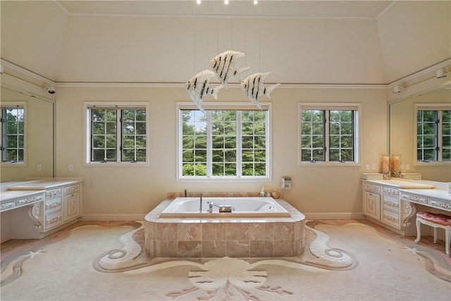 9 Lincoln Woods, Purchase, NY 10577 - bathroom featuring high vaulted ceiling, vanity, a relaxing tiled tub, and a wealth of natural light