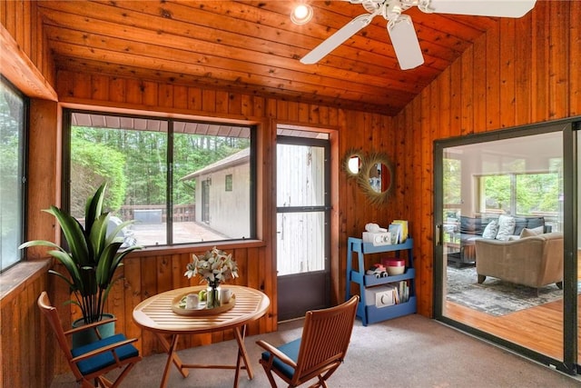 sunroom / solarium featuring lofted ceiling and a wealth of natural light