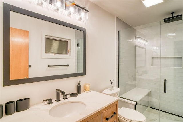 bathroom with vanity, toilet, and an enclosed shower