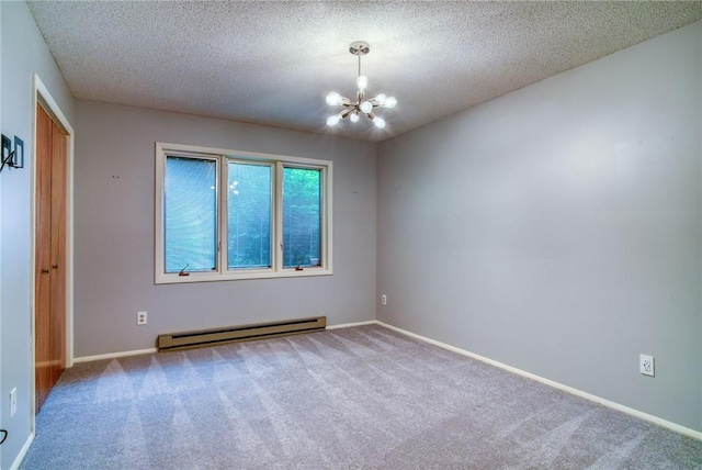 empty room featuring carpet, a notable chandelier, baseboard heating, and a textured ceiling