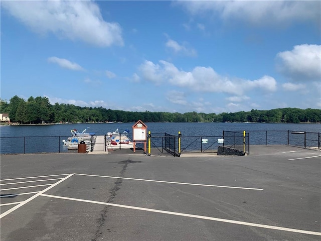 view of parking with a water view