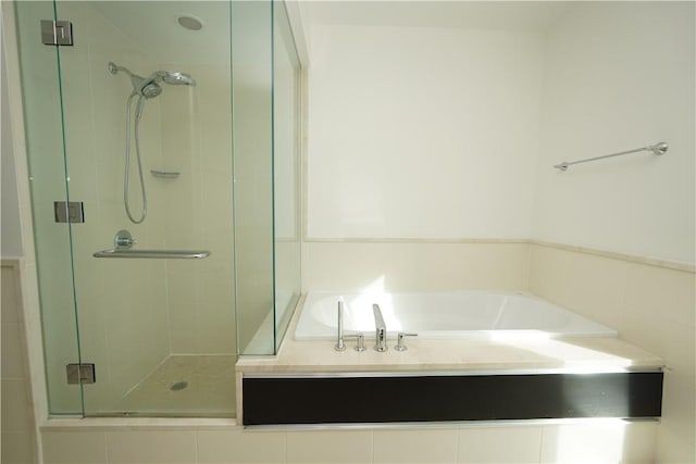 bathroom with separate shower and tub