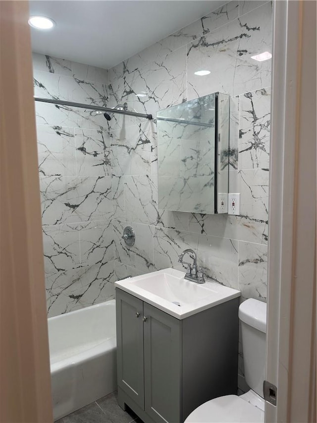 full bathroom featuring vanity,  shower combination, toilet, and tile walls