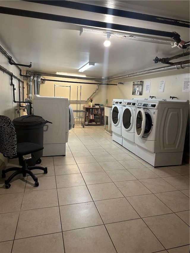 laundry area with light tile patterned floors and separate washer and dryer