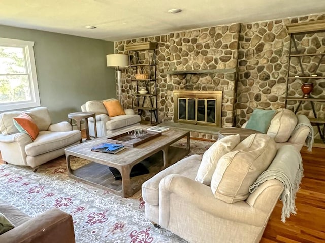 living area with a fireplace and hardwood / wood-style flooring