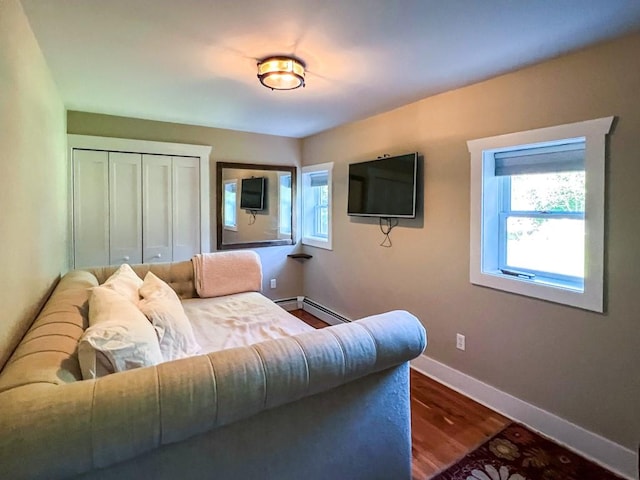 living room with hardwood / wood-style floors and a baseboard heating unit