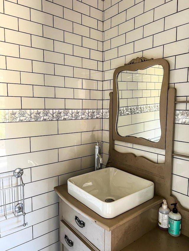 bathroom featuring vanity and tile walls