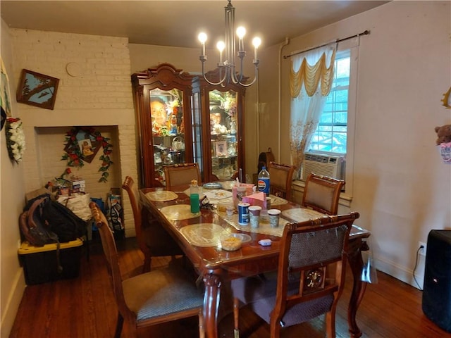 dining area featuring a chandelier, dark hardwood / wood-style flooring, and cooling unit