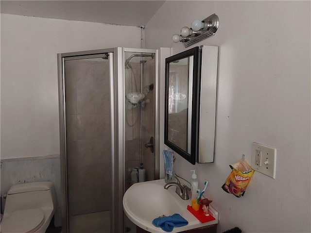 bathroom featuring walk in shower, sink, and toilet