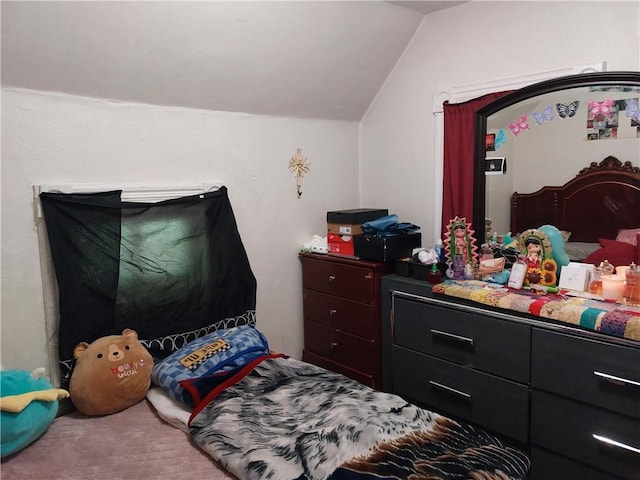 bedroom with carpet flooring and vaulted ceiling