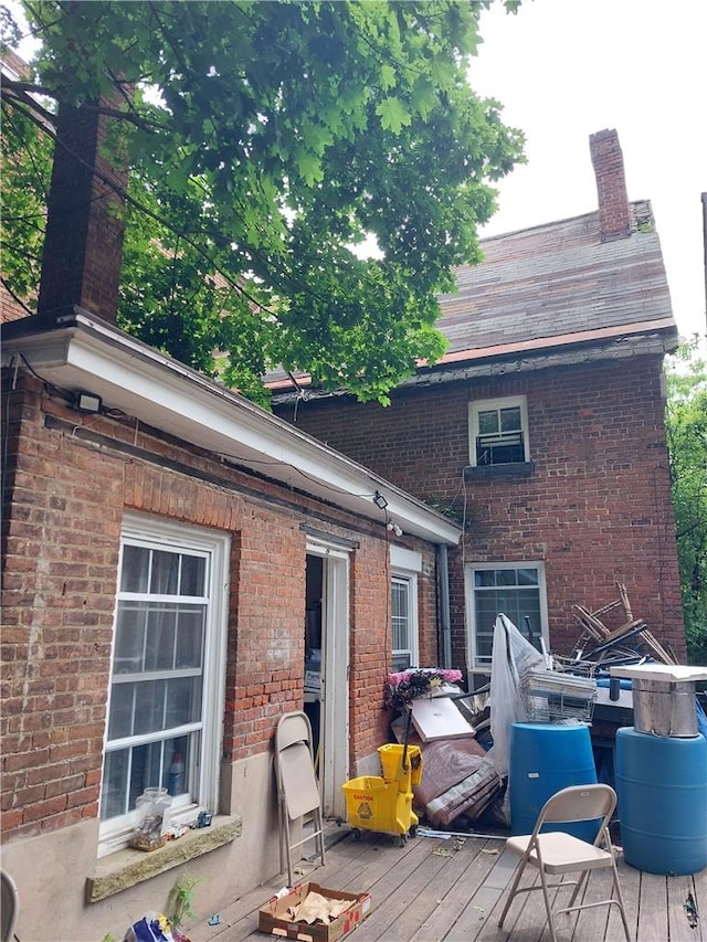 rear view of house featuring a wooden deck