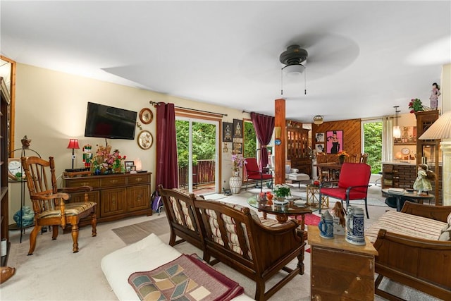 carpeted living room featuring ceiling fan