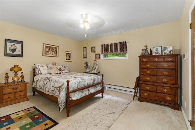 bedroom with ceiling fan, light colored carpet, and a baseboard heating unit