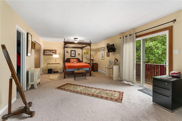 carpeted bedroom featuring access to exterior, a baseboard radiator, and a textured ceiling