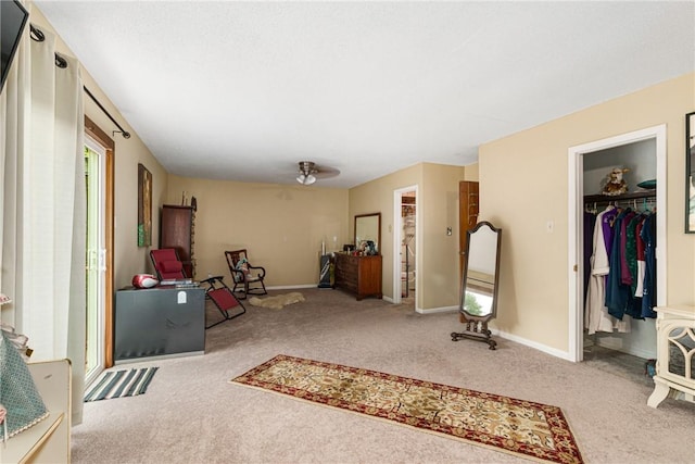 interior space featuring ceiling fan and carpet