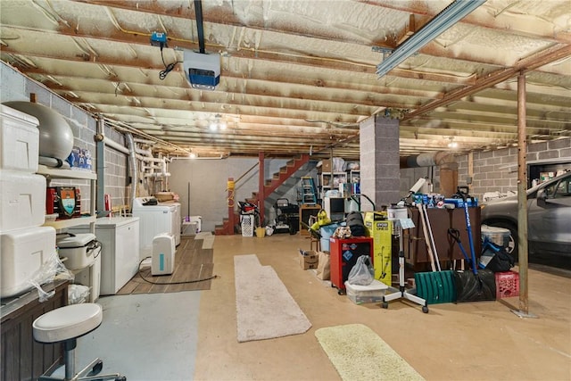 basement with washing machine and clothes dryer and white refrigerator