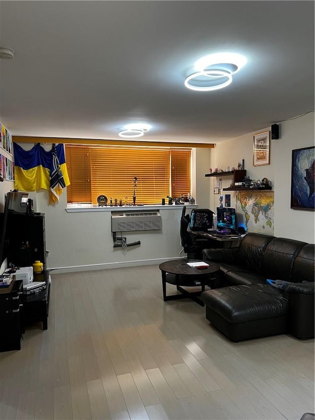 living room with wood-type flooring and a wall unit AC