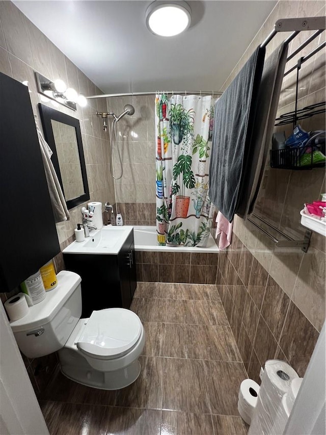 full bathroom featuring shower / bath combo, vanity, toilet, and tile walls