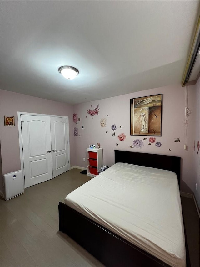 bedroom featuring a closet and hardwood / wood-style flooring