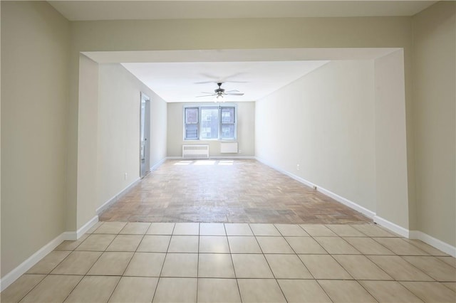 unfurnished room with radiator, ceiling fan, and light parquet floors