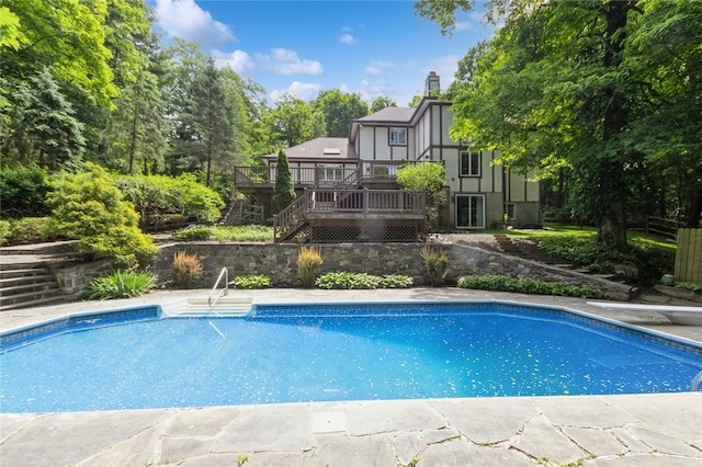 view of swimming pool with a deck