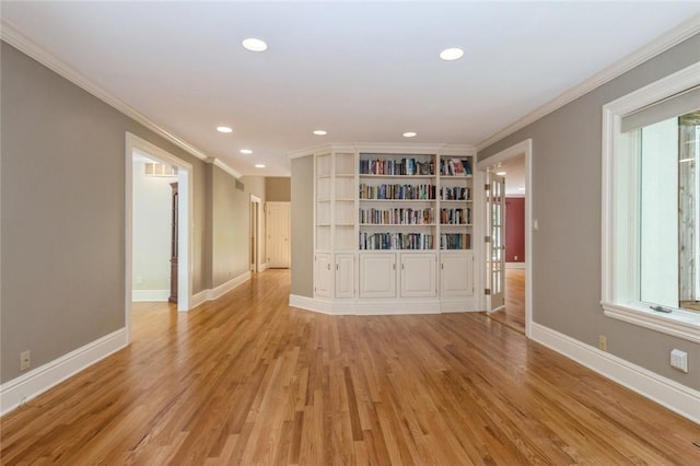 unfurnished room featuring light hardwood / wood-style floors and ornamental molding