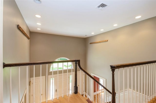 stairs featuring hardwood / wood-style floors