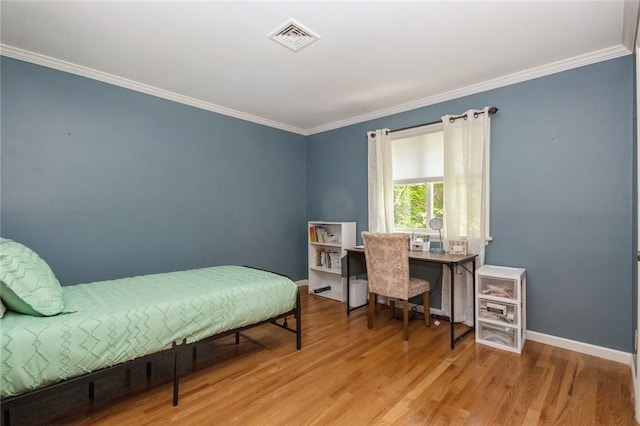 bedroom featuring crown molding and light hardwood / wood-style floors