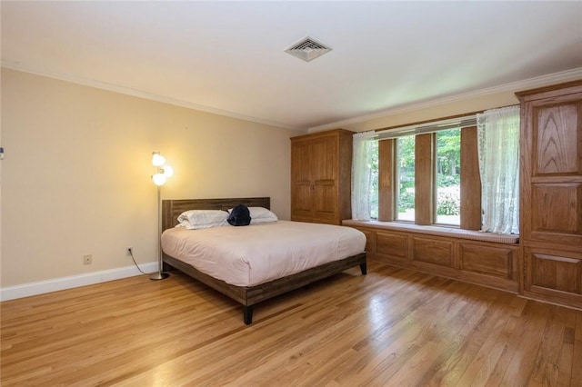 bedroom featuring crown molding and light hardwood / wood-style floors