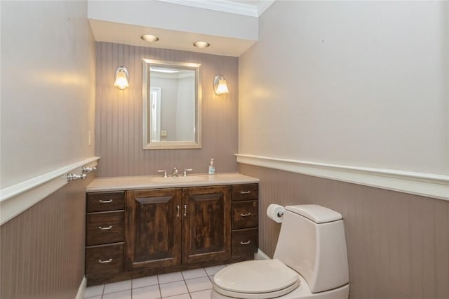 bathroom with vanity, tile patterned floors, crown molding, wooden walls, and toilet