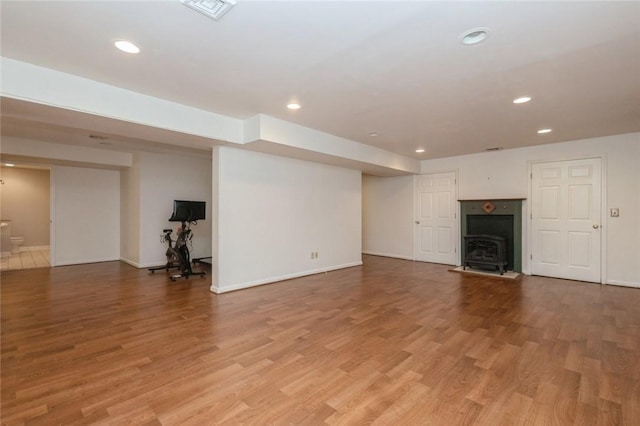 unfurnished living room featuring a fireplace and hardwood / wood-style flooring