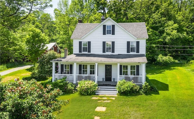 view of front facade with covered porch and a front yard