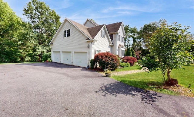 view of home's exterior with a yard and a garage