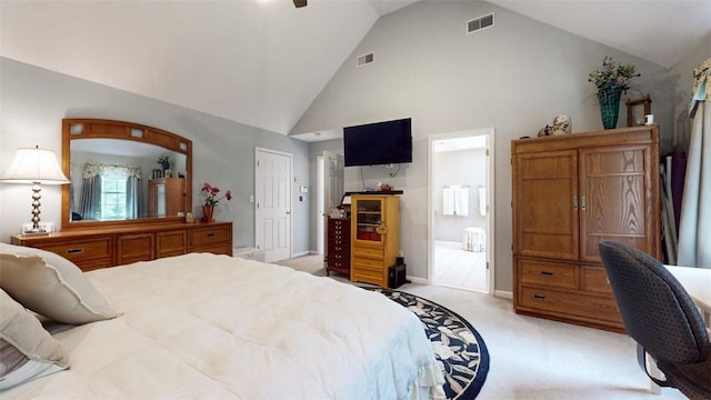 carpeted bedroom with high vaulted ceiling, ensuite bath, and a closet