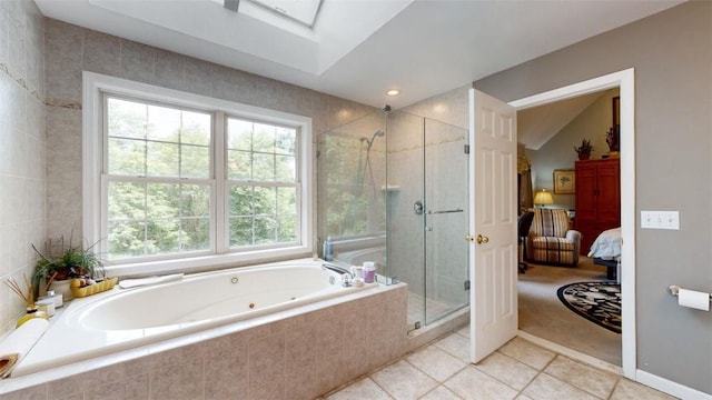 bathroom featuring tile patterned flooring, plus walk in shower, and vaulted ceiling