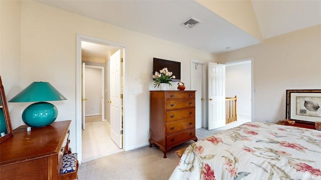 bedroom featuring light colored carpet and lofted ceiling