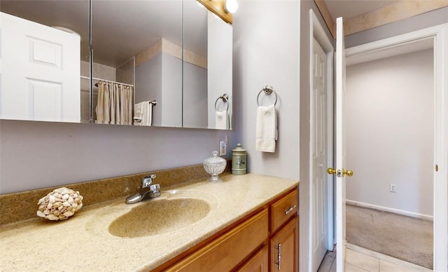 bathroom featuring tile patterned flooring, vanity, and curtained shower