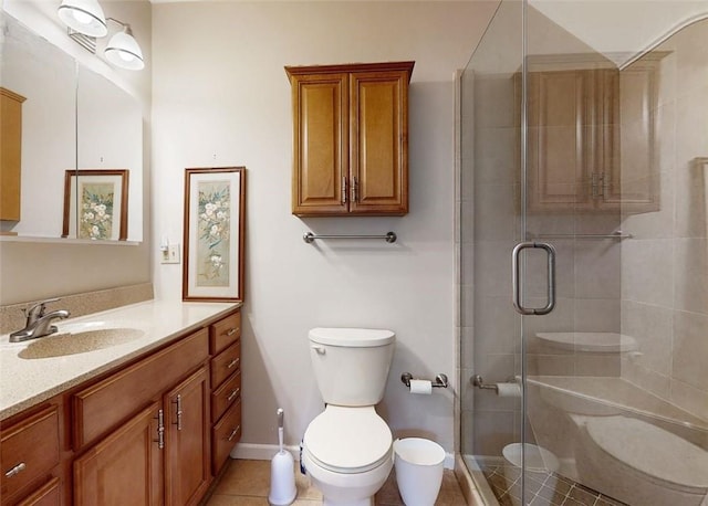 bathroom featuring tile patterned floors, vanity, walk in shower, and toilet