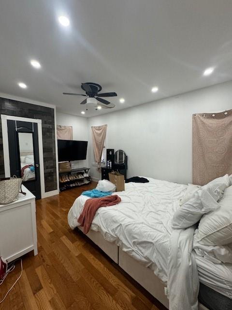 bedroom with ceiling fan and dark wood-type flooring