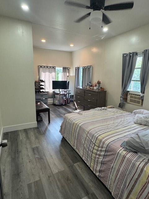 bedroom featuring multiple windows, ceiling fan, and dark wood-type flooring